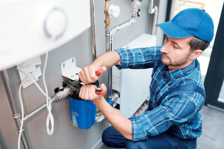 Young,Man,In,Workwear,Using,Pliers,While,Installing,Water,Filtration